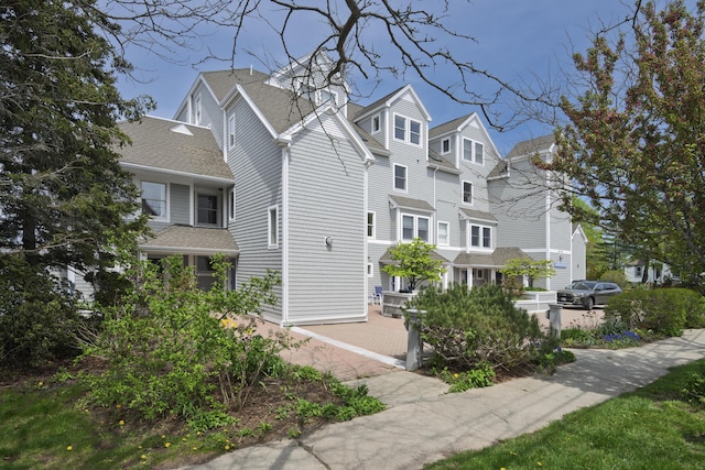 215 High St Unit 101, South Portland, ME 04106 - view of side of home featuring a shingled roof