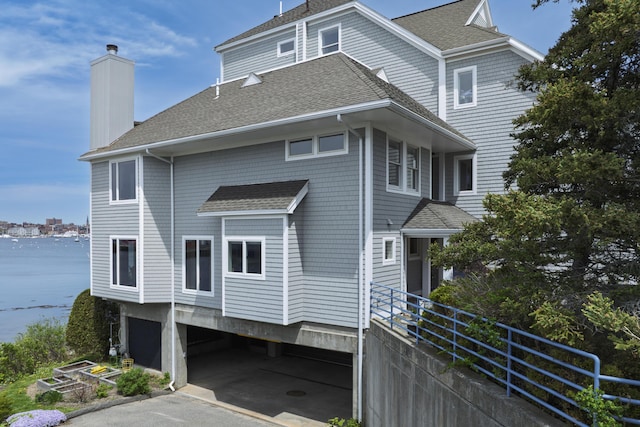 215 High St Unit 101, South Portland, ME 04106 - view of front of house featuring roof with shingles and a chimney
