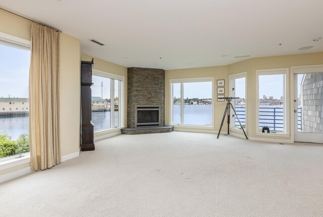 215 High St Unit 101, South Portland, ME 04106 - unfurnished living room featuring a water view, light carpet, and plenty of natural light