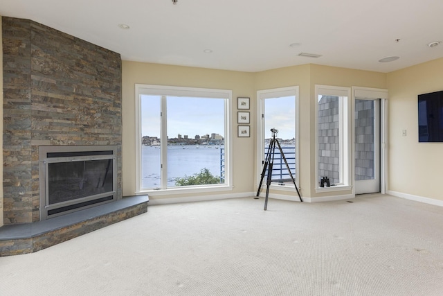 215 High St Unit 101, South Portland, ME 04106 - unfurnished living room featuring carpet floors and a fireplace