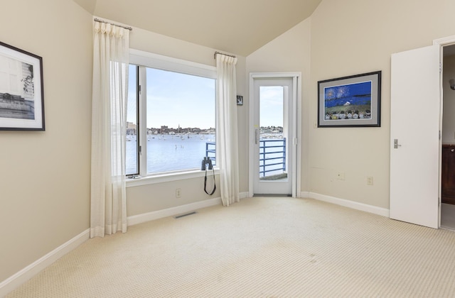 215 High St Unit 101, South Portland, ME 04106 - carpeted spare room with lofted ceiling and a water view