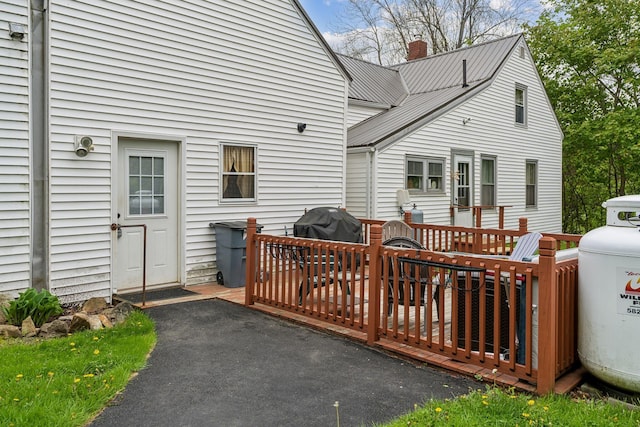 19 Cobbossee Ave, Gardiner, ME 04345 - rear view of house featuring a deck, a chimney, and metal roof