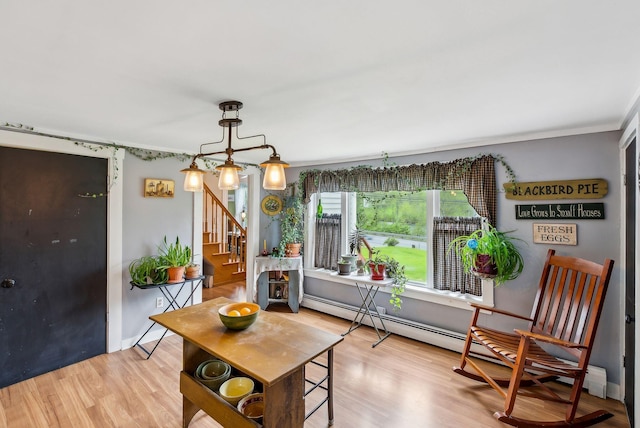 19 Cobbossee Ave, Gardiner, ME 04345 - dining area featuring stairs, wood finished floors, crown molding, and a baseboard heating unit