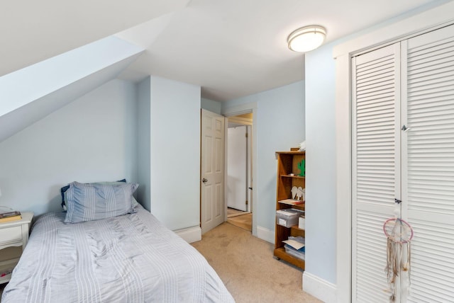19 Cobbossee Ave, Gardiner, ME 04345 - bedroom featuring light colored carpet, a skylight, a closet, baseboards, and lofted ceiling