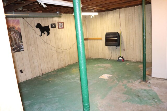 113 Pleasant St, Greenville, ME 04441 - unfinished below grade area featuring wooden walls and heating unit