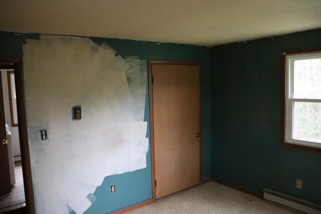 113 Pleasant St, Greenville, ME 04441 - empty room featuring a baseboard heating unit and plenty of natural light