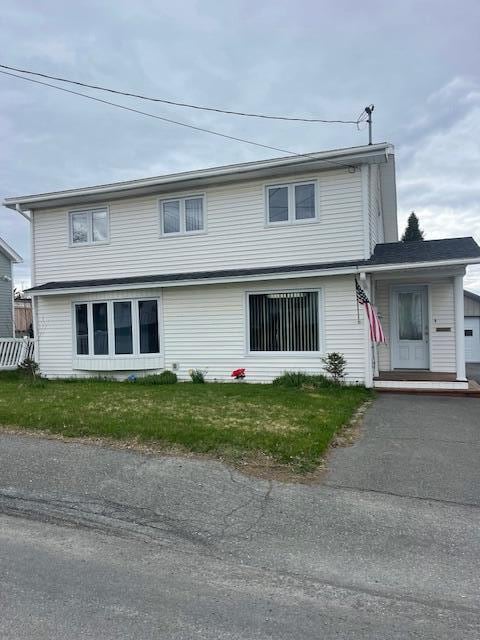 145 12th Ave, Madawaska, ME 04756 - traditional-style home with asphalt driveway and a front lawn