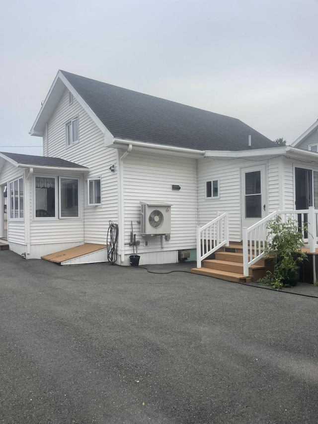 145 12th Ave, Madawaska, ME 04756 - back of house with a cooling unit and roof with shingles