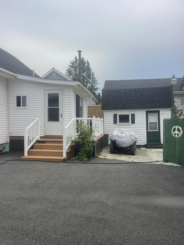 145 12th Ave, Madawaska, ME 04756 - view of front of property featuring entry steps, roof with shingles, and an outbuilding
