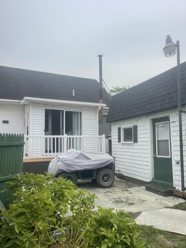 145 12th Ave, Madawaska, ME 04756 - rear view of property featuring a shingled roof, entry steps, and a deck