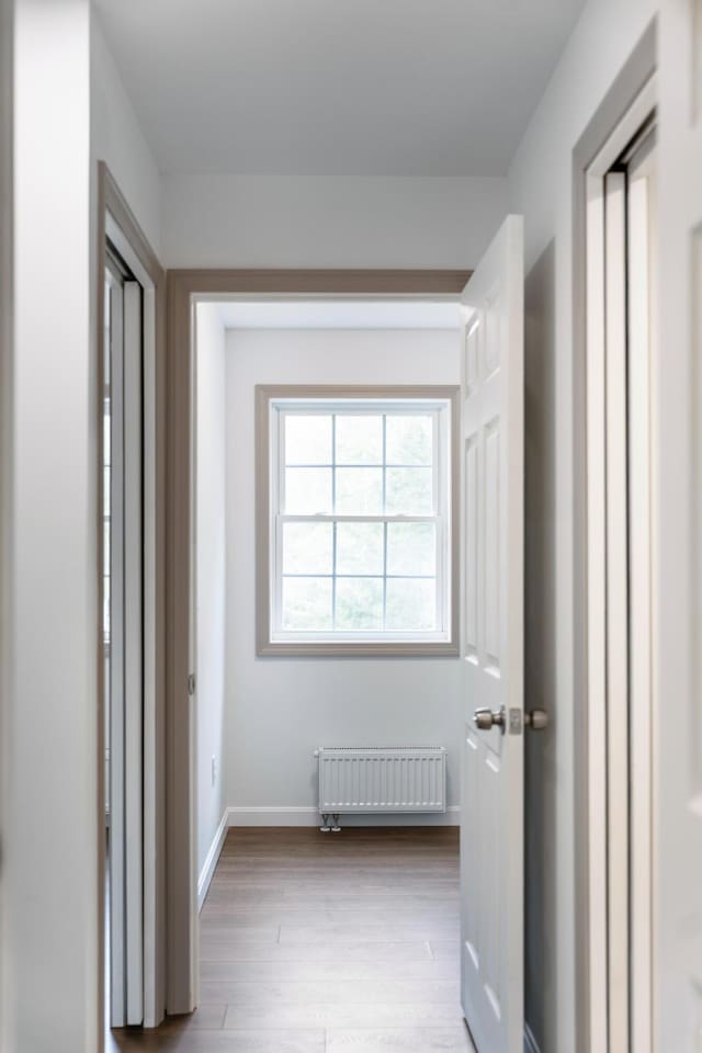 23 Bray Cir, Passadumkeag, ME 04475 - hallway with radiator heating unit, wood finished floors, and baseboards