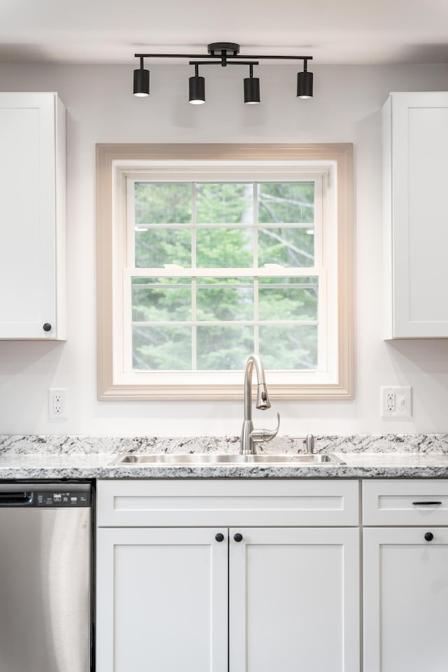 23 Bray Cir, Passadumkeag, ME 04475 - kitchen with stainless steel dishwasher, a sink, white cabinetry, and plenty of natural light