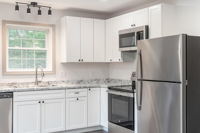 23 Bray Cir, Passadumkeag, ME 04475 - kitchen featuring stainless steel appliances, a sink, and white cabinetry