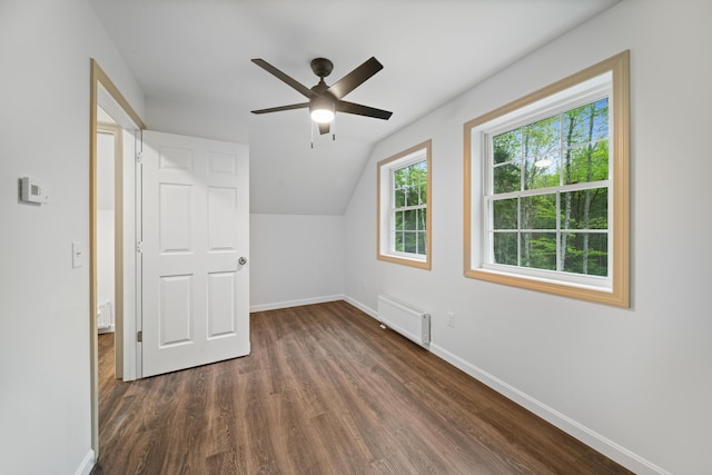23 Bray Cir, Passadumkeag, ME 04475 - additional living space featuring baseboards, ceiling fan, dark wood-style floors, vaulted ceiling, and radiator heating unit