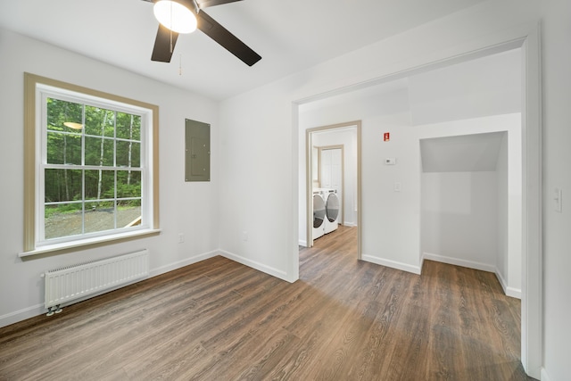 23 Bray Cir, Passadumkeag, ME 04475 - unfurnished room featuring radiator heating unit, washing machine and clothes dryer, electric panel, wood finished floors, and ceiling fan