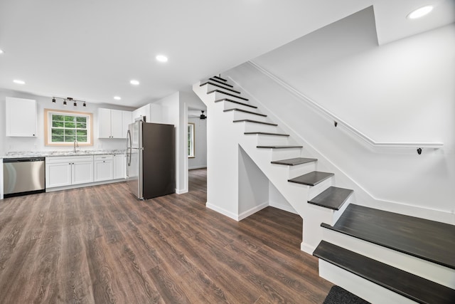 23 Bray Cir, Passadumkeag, ME 04475 - kitchen with stainless steel appliances, dark wood finished floors, light stone counters, a sink, and white cabinets