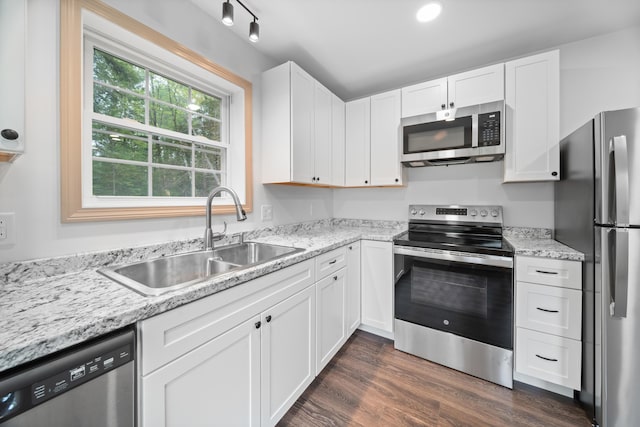 23 Bray Cir, Passadumkeag, ME 04475 - kitchen featuring appliances with stainless steel finishes, a sink, white cabinetry, dark wood-style flooring, and light stone counters