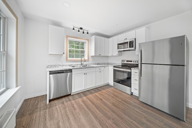 23 Bray Cir, Passadumkeag, ME 04475 - kitchen with appliances with stainless steel finishes, a sink, dark wood-style floors, and white cabinets