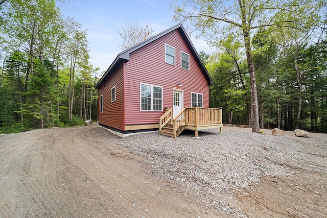 23 Bray Cir, Passadumkeag, ME 04475 - view of front of home with a wooden deck and driveway