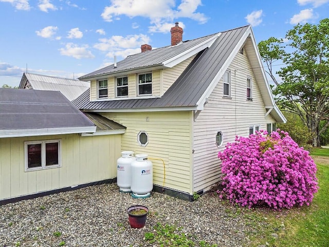 753 Ridge Rd, Windsor, ME 04363 - view of property exterior featuring a chimney and metal roof