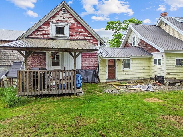 753 Ridge Rd, Windsor, ME 04363 - rear view of property featuring a lawn, metal roof, and a deck