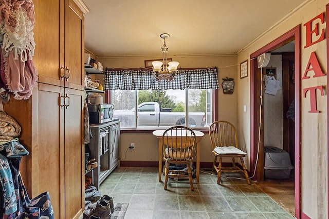 753 Ridge Rd, Windsor, ME 04363 - dining space featuring ornamental molding, a chandelier, and baseboards