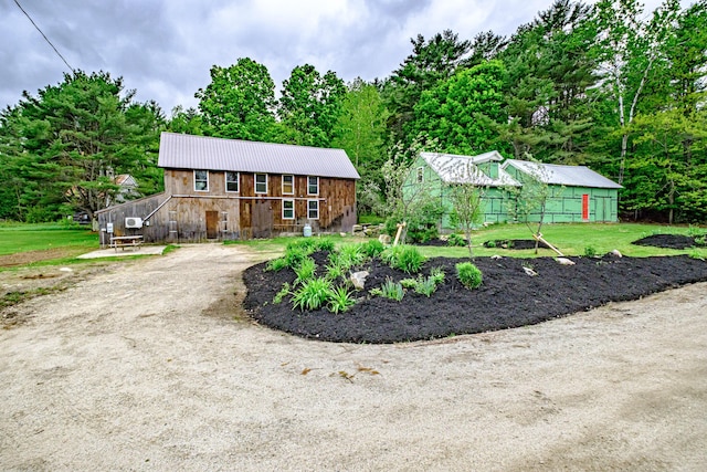 76 Old W Bethel Road, Albany Twp, ME 04217 - chalet / cabin featuring an outbuilding, metal roof, stone siding, and a barn