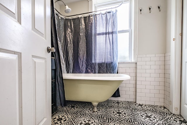 76 Old W Bethel Road, Albany Twp, ME 04217 - full bath with a freestanding bath, tile walls, tile patterned flooring, and a wainscoted wall