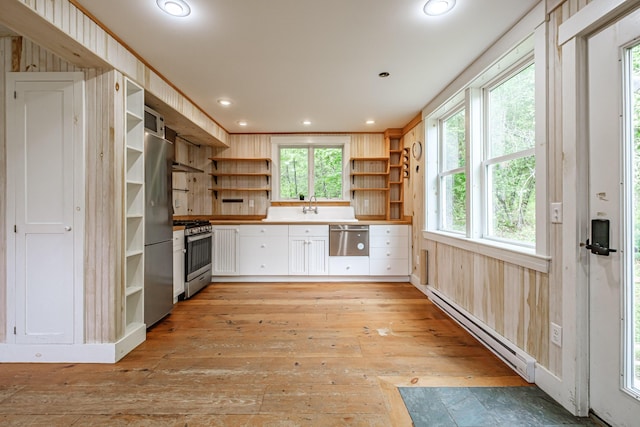 76 Old W Bethel Road, Albany Twp, ME 04217 - kitchen featuring open shelves, baseboard heating, stainless steel appliances, light wood finished floors, and white cabinets