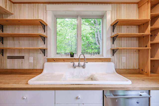 76 Old W Bethel Road, Albany Twp, ME 04217 - kitchen with open shelves, dishwasher, wooden walls, butcher block counters, and white cabinetry