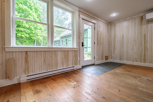 76 Old W Bethel Road, Albany Twp, ME 04217 - doorway with a baseboard radiator, hardwood / wood-style flooring, and an AC wall unit