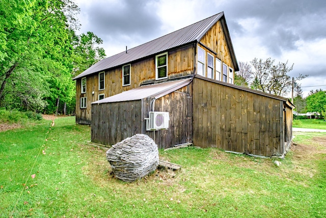 76 Old W Bethel Road, Albany Twp, ME 04217 - back of house featuring a cooling unit, metal roof, and a yard