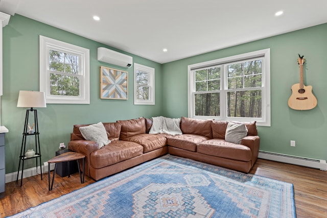 64 Autumn Rdg, Sabattus, ME 04280 - living room with a wall mounted air conditioner, baseboard heating, healthy amount of natural light, wood finished floors, and recessed lighting