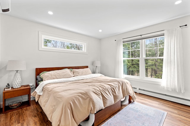 64 Autumn Rdg, Sabattus, ME 04280 - bedroom featuring multiple windows, wood finished floors, recessed lighting, and a baseboard radiator