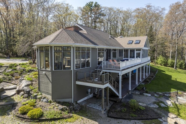 50 Higbee Ln, Boothbay, ME 04571 - back of house with a sunroom, stairs, a wooden deck, a shingled roof, and a yard