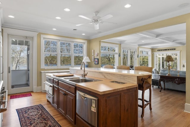 50 Higbee Ln, Boothbay, ME 04571 - kitchen with dishwasher, a kitchen island with sink, a breakfast bar, crown molding, and light wood-type flooring