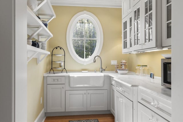 50 Higbee Ln, Boothbay, ME 04571 - washroom with a sink, ornamental molding, and wood finished floors