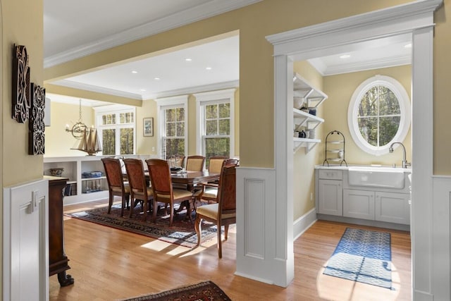 50 Higbee Ln, Boothbay, ME 04571 - dining space with light wood-type flooring, healthy amount of natural light, crown molding, and a chandelier