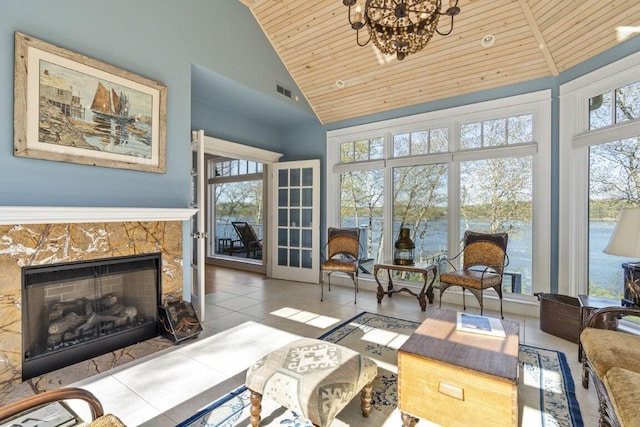 50 Higbee Ln, Boothbay, ME 04571 - tiled living room with wooden ceiling, high vaulted ceiling, a fireplace, and a chandelier