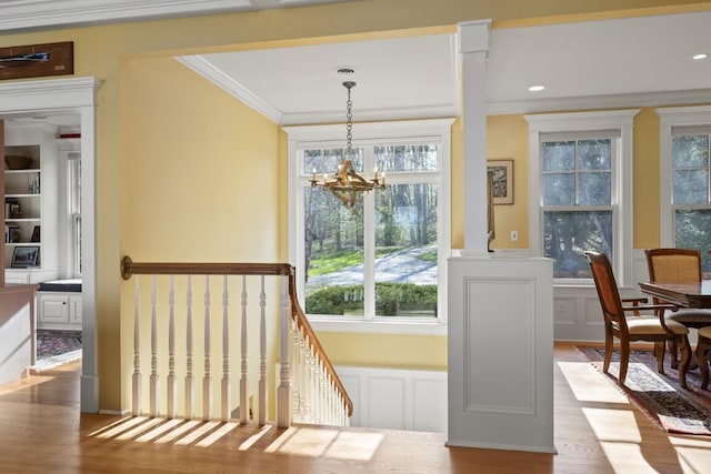 50 Higbee Ln, Boothbay, ME 04571 - doorway with ornamental molding, a decorative wall, plenty of natural light, a chandelier, and wood finished floors