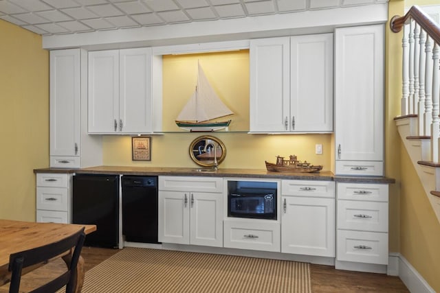 50 Higbee Ln, Boothbay, ME 04571 - kitchen with black microwave, dark wood-style floors, white cabinetry, and fridge