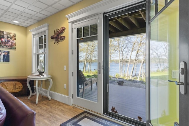50 Higbee Ln, Boothbay, ME 04571 - doorway to outside with a water view, wood finished floors, healthy amount of natural light, and baseboards