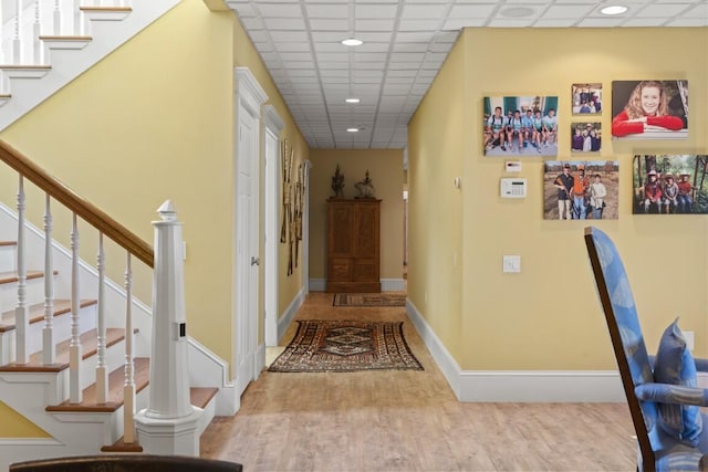 50 Higbee Ln, Boothbay, ME 04571 - corridor with wood finished floors, baseboards, a paneled ceiling, stairs, and recessed lighting