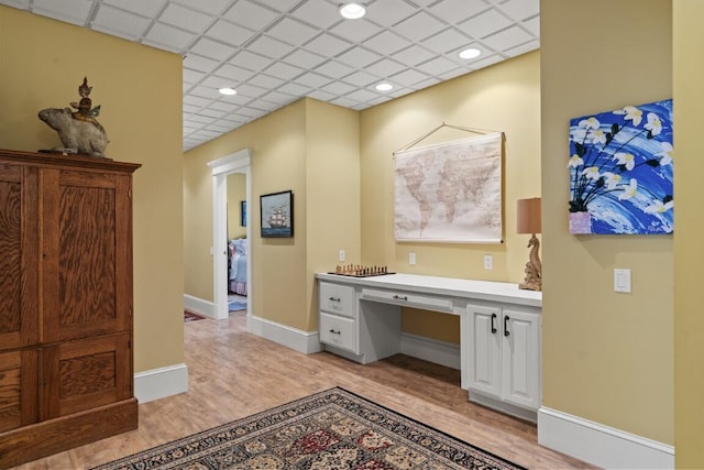 50 Higbee Ln, Boothbay, ME 04571 - home office featuring built in study area, light wood-type flooring, baseboards, and a paneled ceiling
