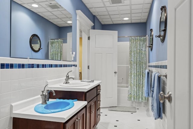 50 Higbee Ln, Boothbay, ME 04571 - bathroom with tile walls, vanity, tile patterned floors, shower / bath combo with shower curtain, and a wainscoted wall