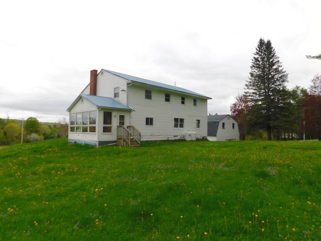 81 S Main St, Athens, ME 04912 - back of property with a chimney, a sunroom, and a lawn
