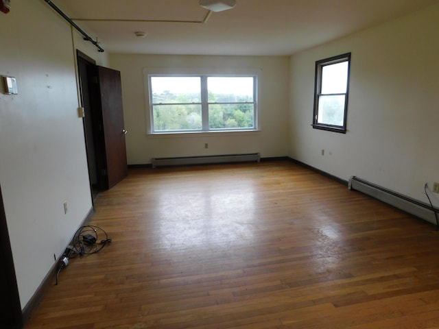 81 S Main St, Athens, ME 04912 - empty room featuring baseboard heating, wood finished floors, and baseboards