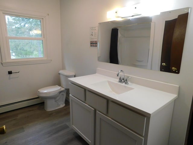 81 S Main St, Athens, ME 04912 - full bath with wood finished floors, toilet, vanity, and baseboard heating