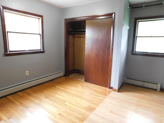 81 S Main St, Athens, ME 04912 - unfurnished bedroom featuring a baseboard radiator, a closet, and wood finished floors