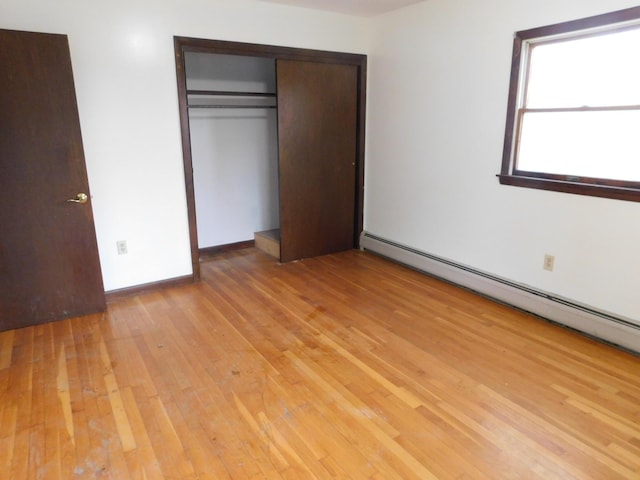 81 S Main St, Athens, ME 04912 - unfurnished bedroom featuring light wood finished floors, baseboard heating, and a closet